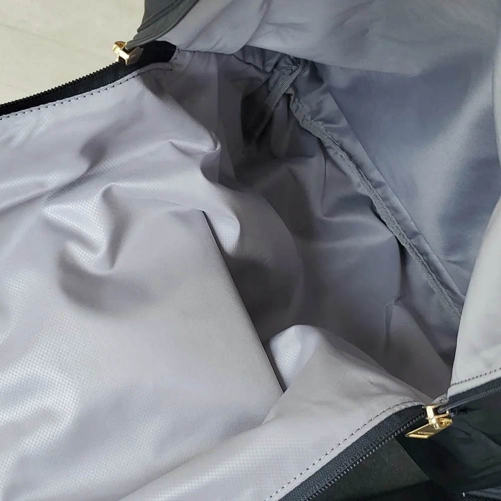 NWOT Tumi Just in Case Backpack in Black and Gold